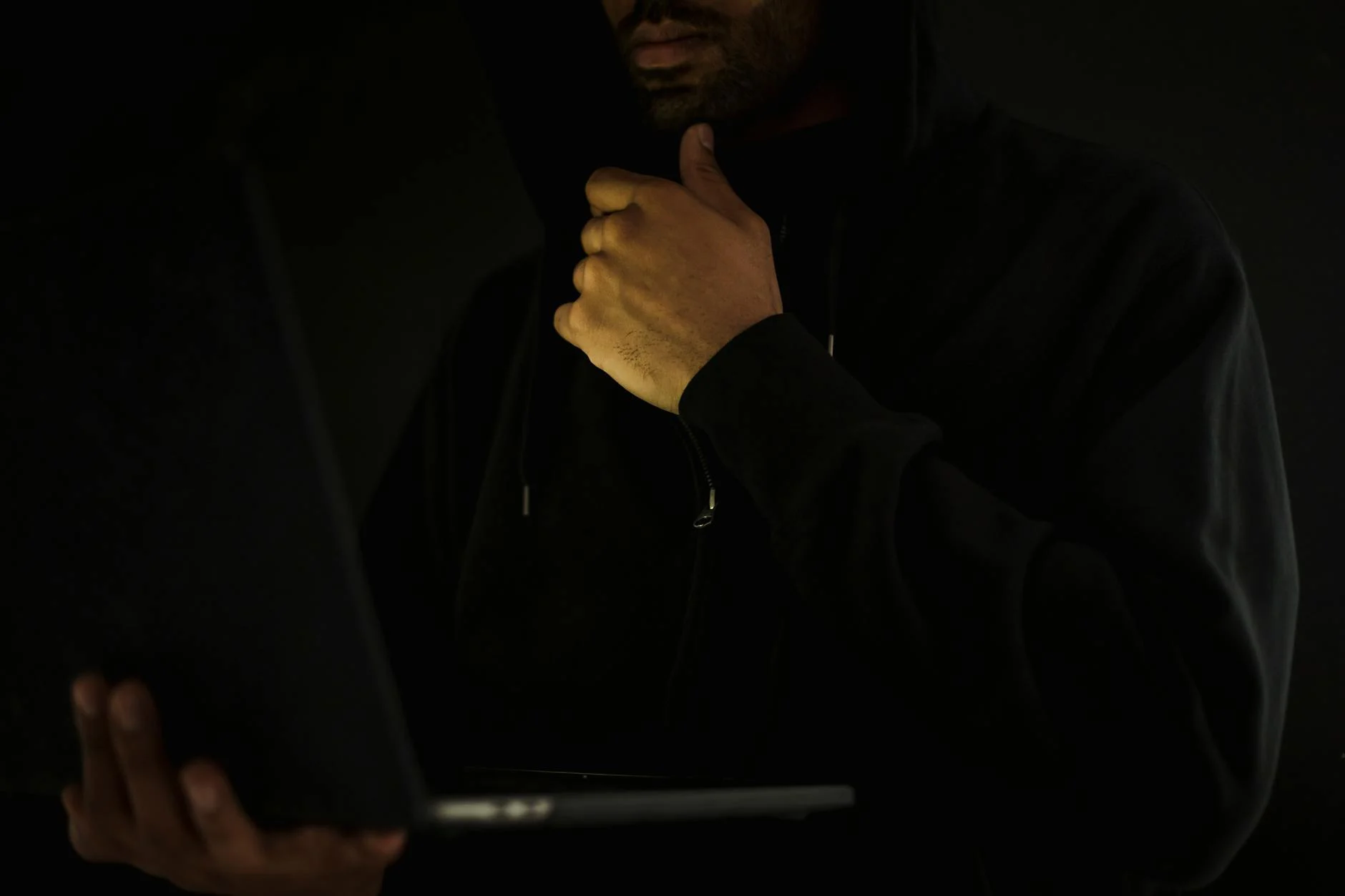 Person typing on a laptop, hands poised over the keyboard, symbolizing the meticulous process of writing SEO-optimized content.